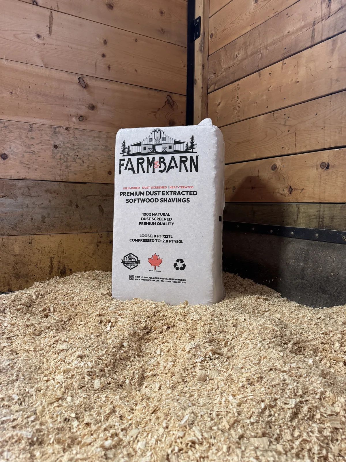 Farm & Barn softwood shavings bag beside fresh shavings bedding in a stall