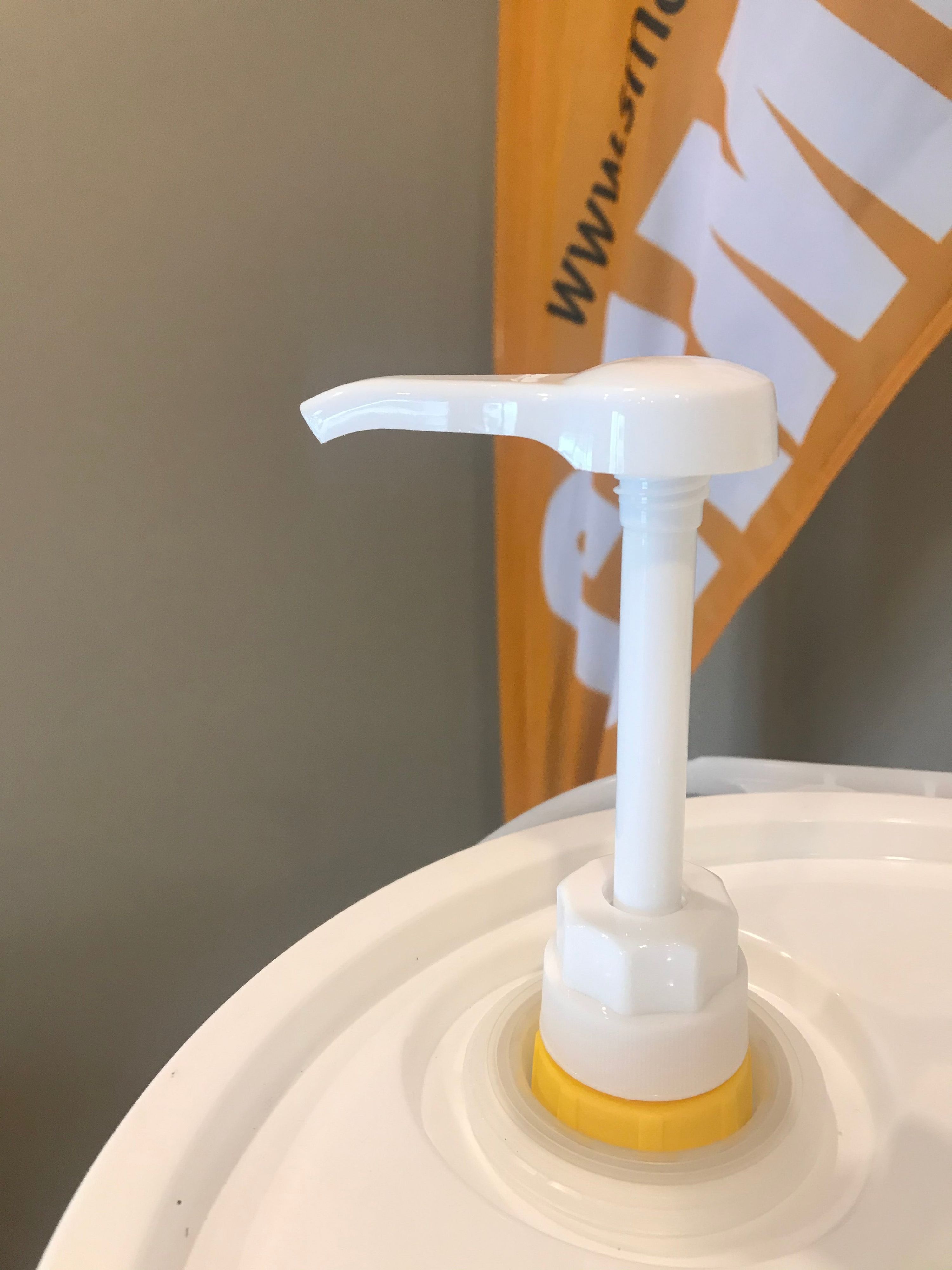 Smart Earth pail pump fitted into the lid adapter on a camelina oil pail