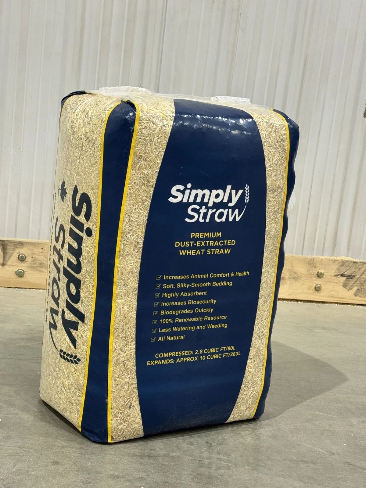 Simply Straw premium dust-extracted wheat straw 80 L compressed bale with the label facing up